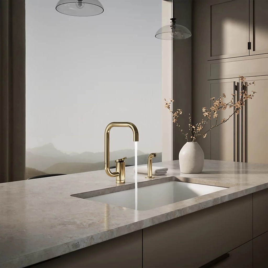 Modern residential kitchen with gold faucet and marble countertop in Ottawa